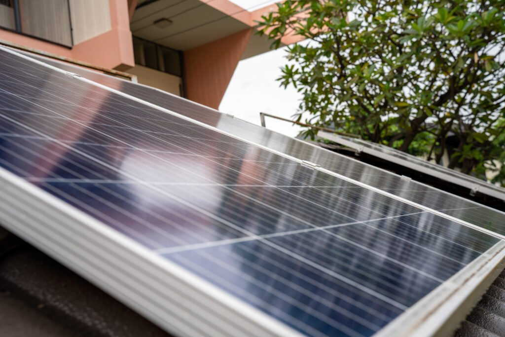 blue solar photo voltaic panels system apartment building sunny day renewable ecological green energy scaled